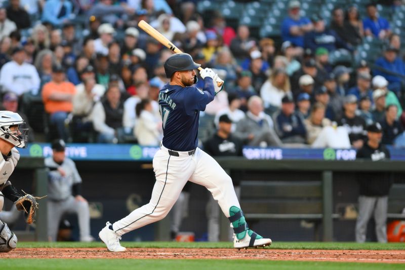 Jun 12, 2024; Seattle, Washington, USA; Seattle Mariners first baseman Tyler Locklear (27) hits a single against the Chicago White Sox during the eighth inning at T-Mobile Park. Mandatory Credit: Steven Bisig-USA TODAY Sports