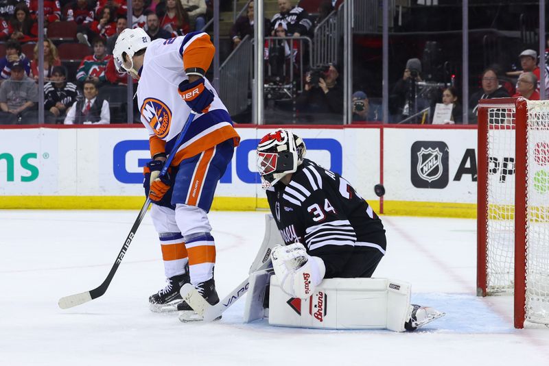 Apr 15, 2024; Newark, New Jersey, USA; New York Islanders center Kyle Palmieri (21) scores a goal on New Jersey Devils goaltender Jake Allen (34) during the first period at Prudential Center. Mandatory Credit: Ed Mulholland-USA TODAY Sports