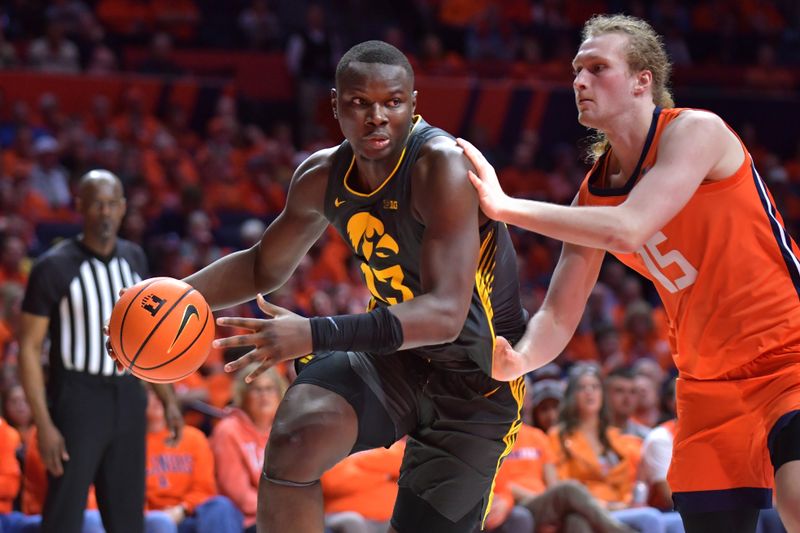 Feb 25, 2025; Champaign, Illinois, USA;  Iowa Hawkeyes forward Ladji Dembele (13) drives the ball against Illinois Fighting Illini forward Jake Davis (15) during the second half at State Farm Center. Mandatory Credit: Ron Johnson-Imagn Images