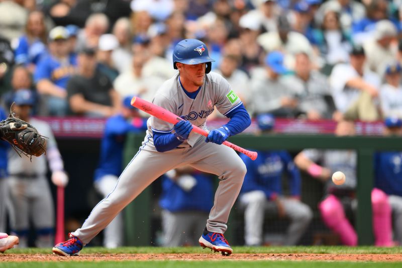 May 11, 2025; Seattle, Washington, USA; Toronto Blue Jays center fielder Myles Straw (3) hits a sacrifice bunt against the Seattle Mariners during the sixth inning at T-Mobile Park. Mandatory Credit: Steven Bisig-Imagn Images