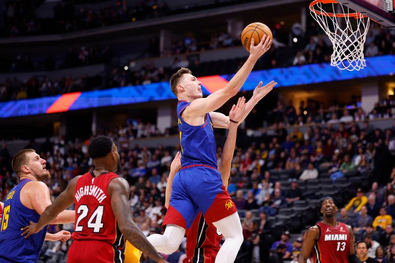 DENVER, COLORADO - NOVEMBER 8: Christian Braun #0 of the Denver Nuggets goes to the basket against the Miami Heat during the fourth quarter at Ball Arena on November 8, 2024 in Denver, Colorado. NOTE TO USER: User expressly acknowledges and agrees that, by downloading and or using this photograph, User is consenting to the terms and conditions of the Getty Images License Agreement. (Photo by C. Morgan Engel/Getty Images)