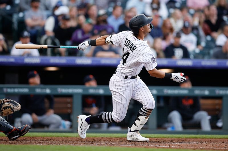 Jun 30, 2023; Denver, Colorado, USA; Colorado Rockies shortstop Ezequiel Tovar (14) watches his ball on a three run home run in the sixth inning against the Detroit Tigers at Coors Field. Mandatory Credit: Isaiah J. Downing-USA TODAY Sports