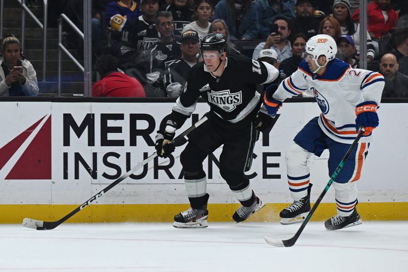 Feb 26, 2026; Los Angeles, California, USA; Los Angeles Kings right wing Corey Perry (10) and Edmonton Oilers defenseman Evan Bouchard (2) battle for the puck during the second period at Crypto.com Arena. Mandatory Credit: Griffin Hooper-Imagn Images  