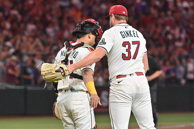 May 8, 2025; Phoenix, Arizona, USA; Arizona Diamondbacks catcher Gabriel Moreno (14) celebrates with pitcher Kevin Ginkel (37) after beating the Los Angeles Dodgers at Chase Field. Mandatory Credit: Matt Kartozian-Imagn Images