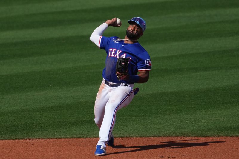 Feb 28, 2024; Surprise, Arizona, USA; Texas Rangers shortstop Ezequiel Duran (20) throws to first base against the Los Angeles Dodgers during the third inning at Surprise Stadium. Mandatory Credit: Joe Camporeale-USA TODAY Sports