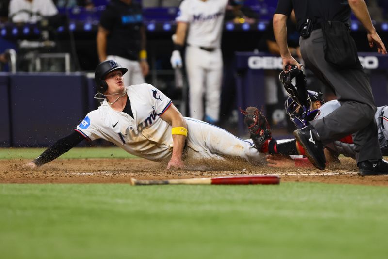 Sep 4, 2024; Miami, Florida, USA; Miami Marlins right fielder Griffin Conine (56) slides at home plate and scores after a double by catcher Nick Fortes (not pictured) against the Washington Nationals during the sixth inning at loanDepot Park. Mandatory Credit: Sam Navarro-Imagn Images