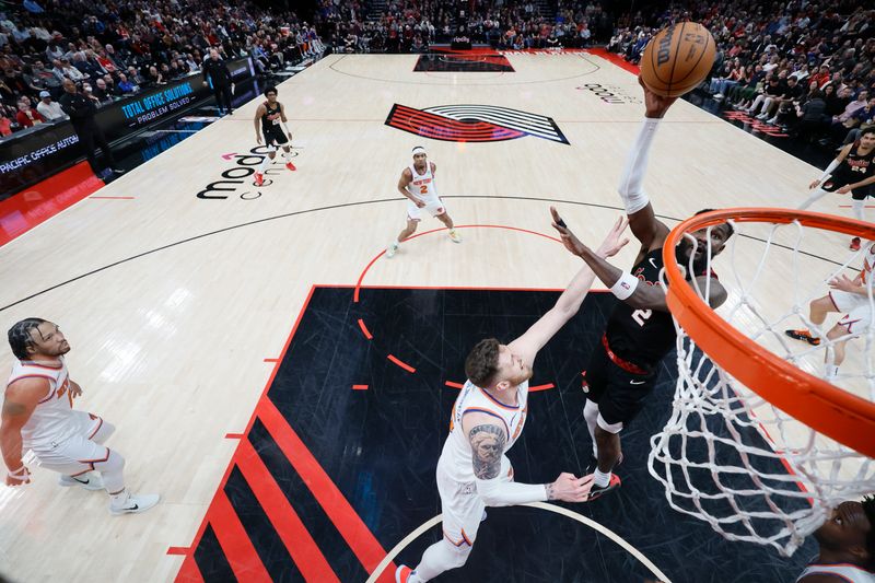 PORTLAND, OREGON - MARCH 14: Deandre Ayton #2 of the Portland Trail Blazers shoots the ball over Isaiah Hartenstein #55 of the New York Knicks during the first half at Moda Center on March 14, 2024 in Portland, Oregon. NOTE TO USER: User expressly acknowledges and agrees that, by downloading and or using this photograph, User is consenting to the terms and conditions of the Getty Images License Agreement.  (Photo by Soobum Im/Getty Images)