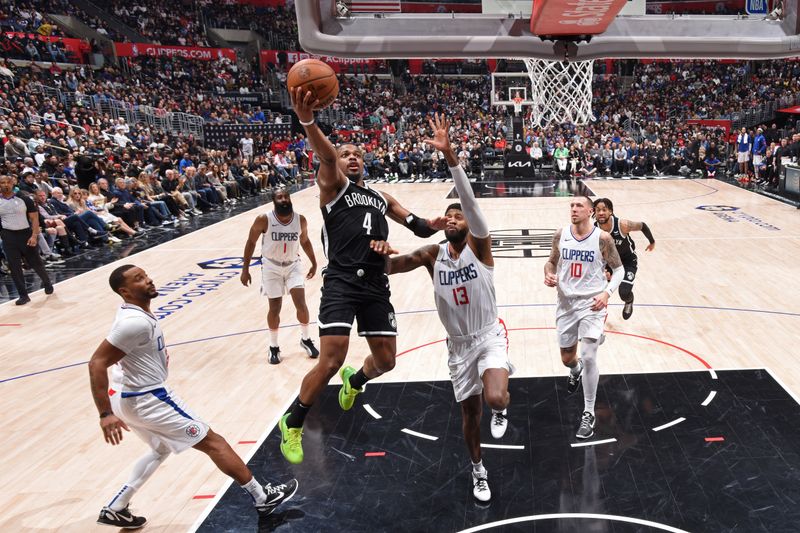 LOS ANGELES, CA - JANUARY 21: Dennis Smith Jr. #4 of the Brooklyn Nets drives to the basket during the game against the LA Clippers on January 21, 2024 at Crypto.Com Arena in Los Angeles, California. NOTE TO USER: User expressly acknowledges and agrees that, by downloading and/or using this Photograph, user is consenting to the terms and conditions of the Getty Images License Agreement. Mandatory Copyright Notice: Copyright 2024 NBAE (Photo by Adam Pantozzi/NBAE via Getty Images)