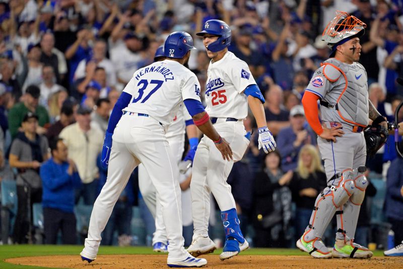 Oct 20, 2024; Los Angeles, California, USA; Los Angeles Dodgers shortstop Tommy Edman (25) celebrates with outfielder Teoscar Hernandez (37) after scoring on a two run home run in the third inning against the New York Mets during game six of the NLCS for the 2024 MLB playoffs at Dodger Stadium. Mandatory Credit: Jayne Kamin-Oncea-Imagn Images