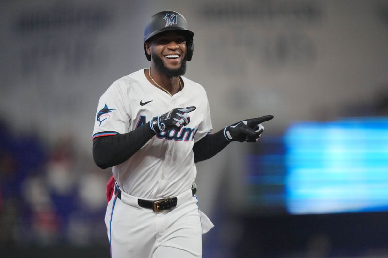 Jun 4, 2024; Miami, Florida, USA; Miami Marlins designated hitter Bryan De La Cruz (14) rounds the bases after hitting a home run against the Tampa Bay Rays in the first inning at loanDepot Park. Mandatory Credit: Jim Rassol-USA TODAY Sports