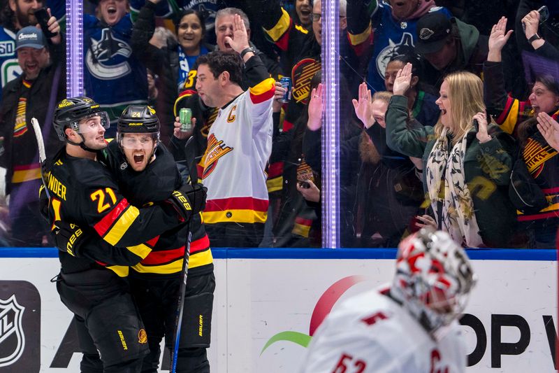 Oct 28, 2024; Vancouver, British Columbia, CAN; Vancouver Canucks forward Nils Hoglander (21) and  forward Pius Suter (24) celebrate Suter’s goal against the Carolina Hurricanes during the third period at Rogers Arena. Mandatory Credit: Bob Frid-Imagn Images