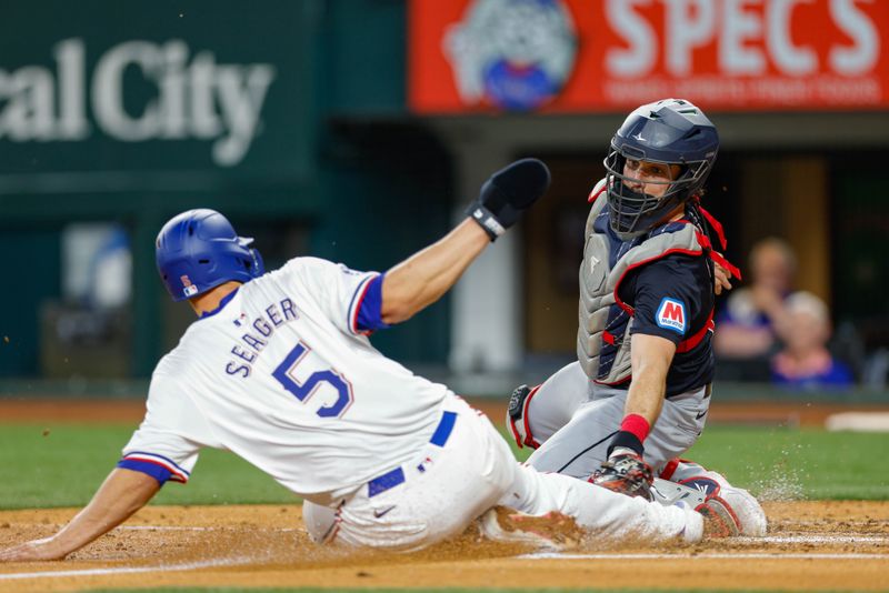 May 15, 2024; Arlington, Texas, USA; Cleveland Guardians catcher Austin Hedges (27) tags Texas Rangers shortstop Corey Seager (5) out at the plate during the fourth inning at Globe Life Field. Mandatory Credit: Andrew Dieb-USA TODAY Sports