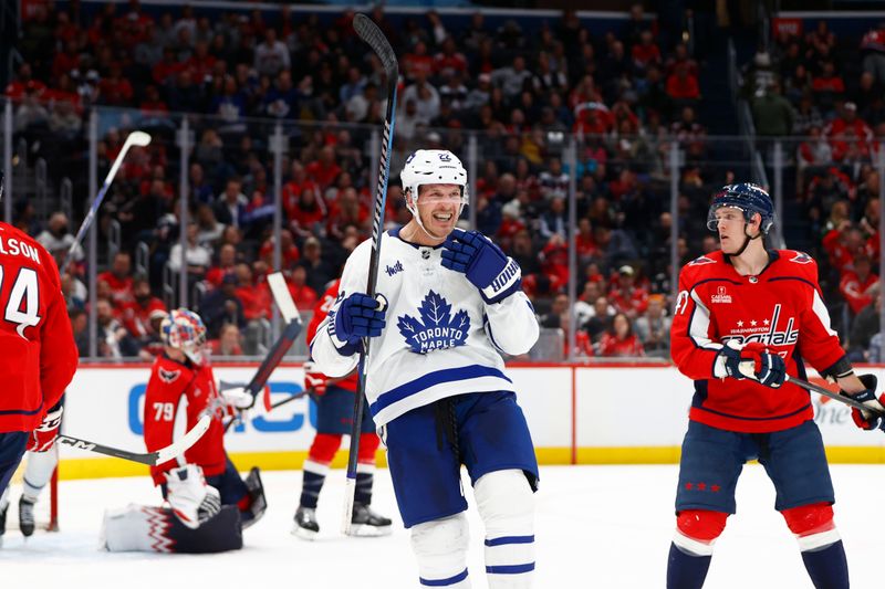 Mar 20, 2024; Washington, District of Columbia, USA; Toronto Maple Leafs defenseman Jake McCabe (22) celebrates after scoring a goal against the Washington Capitals during the second period at Capital One Arena. Mandatory Credit: Amber Searls-USA TODAY Sports