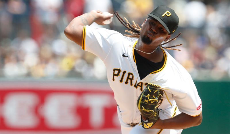 Jul 7, 2024; Pittsburgh, Pennsylvania, USA;  Pittsburgh Pirates starting pitcher Luis L. Ortiz (48) delivers pitch against the New York Mets during the first inning at PNC Park. Mandatory Credit: Charles LeClaire-USA TODAY Sports