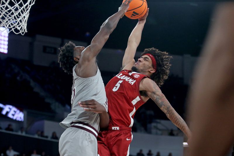 Jan 13, 2026; Starkville, Mississippi, USA; Alabama Crimson Tide forward Amari Allen (5) drives to the basket as Mississippi State Bulldogs center Quincy Ballard (15) defends during the second half at Humphrey Coliseum. Mandatory Credit: Petre Thomas-Imagn Images