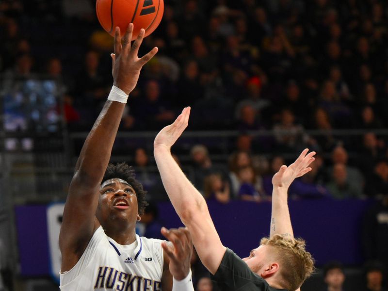Jan 15, 2025; Seattle, Washington, USA; Washington Huskies forward Great Osobor (1) shoots the ball over Purdue Boilermakers forward Caleb Furst (1) during the second half at Alaska Airlines Arena at Hec Edmundson Pavilion. Mandatory Credit: Steven Bisig-Imagn Images