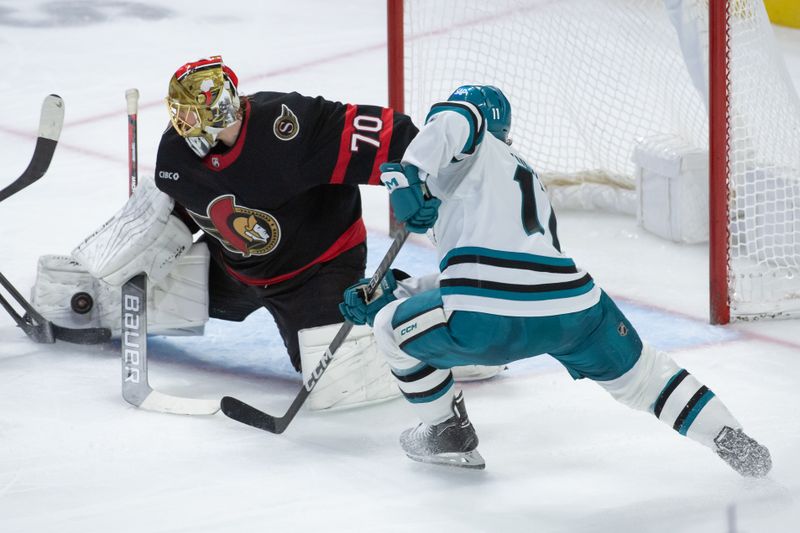 Jan 13, 2024; Ottawa, Ontario, CAN; Ottawa Senators goalie Joonas Korpisalo (70) makes a save in front of San Jose Sharks center Luke Kunin (11) in the third period at the Canadian Tire Centre. Mandatory Credit: Marc DesRosiers-USA TODAY Sports