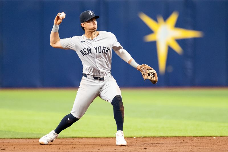 May 11, 2024; St. Petersburg, Florida, USA; New York Yankees shortstop Anthony Volpe (11) throws the ball to first base against the Tampa Bay Rays during the third inning at Tropicana Field. Mandatory Credit: Matt Pendleton-USA TODAY Sports