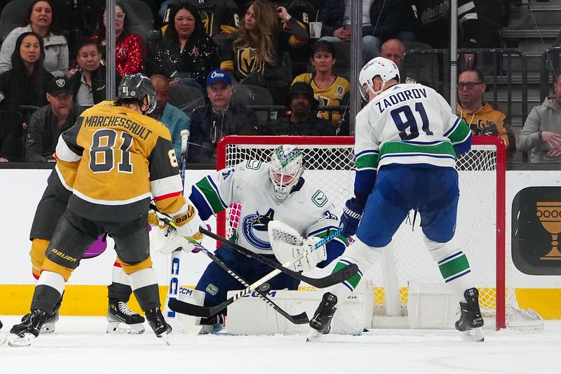 Mar 7, 2024; Las Vegas, Nevada, USA; Vancouver Canucks defenseman Nikita Zadorov (91) looks to clear the puck after Vancouver Canucks goaltender Thatcher Demko (35) made a save against the Vegas Golden Knights during the third period at T-Mobile Arena. Mandatory Credit: Stephen R. Sylvanie-USA TODAY Sports