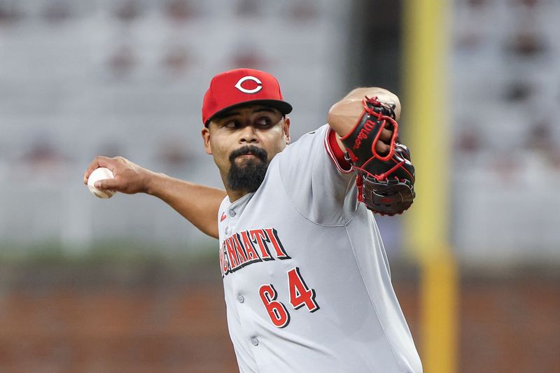 May 6, 2025; Cumberland, Georgia, USA; Cincinnati Reds pitcher Tony Santillan (64) pitches the ball against the Atlanta Braves during the seventh inning at Truist Park. Mandatory Credit: Jordan Godfree-Imagn Images