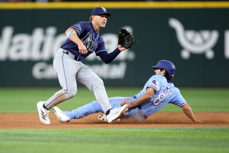 Apr 6, 2025; Arlington, Texas, USA; (Editors Notes: Caption Correction) Texas Rangers third base Josh Smith (8) steals second base as Tampa Bay Rays shortstop Taylor Walls (6) defends during the third inning at Globe Life Field. Mandatory Credit: Tim Heitman-Imagn Images