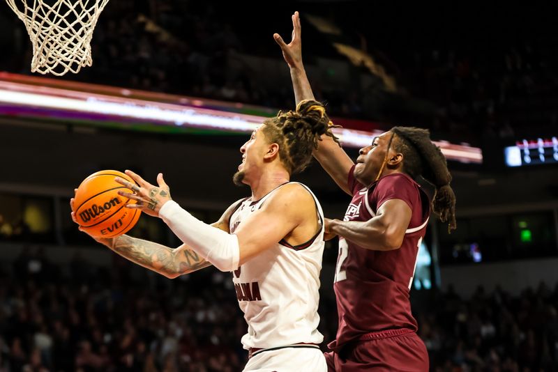 Jan 6, 2024; Columbia, South Carolina, USA; South Carolina Gamecocks guard Myles Stute (10) drives past Mississippi State Bulldogs forward KeShawn Murphy (12) in the first half at Colonial Life Arena. Mandatory Credit: Jeff Blake-USA TODAY Sports