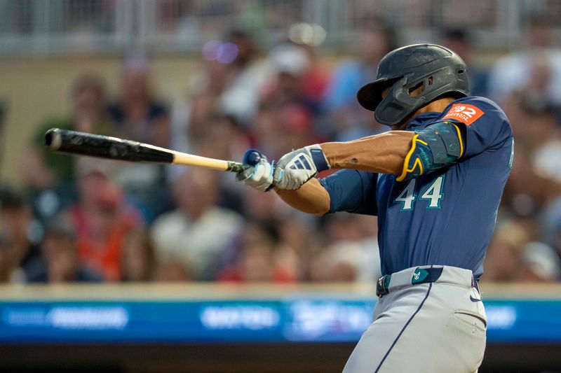 Jun 24, 2025; Minneapolis, Minnesota, USA; Seattle Mariners center fielder Julio Rodriguez (44) hits an RBI sacrifice fly ball against the Minnesota Twins in the ninth inning at Target Field. Mandatory Credit: Jesse Johnson-Imagn Images