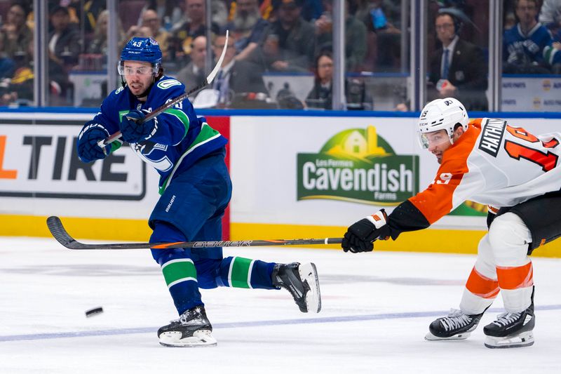 Oct 11, 2024; Vancouver, British Columbia, CAN; Vancouver Canucks defenseman Quinn Hughes (43) passes around Philadelphia Flyers forward Garnet Hathaway (19) during the third period at Rogers Arena. Mandatory Credit: Bob Frid-Imagn Images