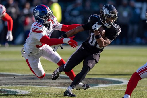 Philadelphia Eagles wide receiver Jahan Dotson (83) runs with the ball after the catch against New York Giants corner back Divaad Wilson (39) during the NFL football game, Sunday, Jan. 5, 2025, in Philadelphia. (AP Photo/Chris Szagola)