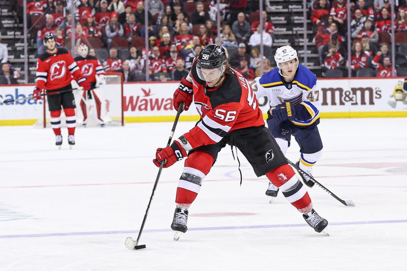 Mar 7, 2024; Newark, New Jersey, USA; New Jersey Devils left wing Erik Haula (56) scores an empty net goal in front of St. Louis Blues defenseman Torey Krug (47) during the third period at Prudential Center. Mandatory Credit: Vincent Carchietta-USA TODAY Sports