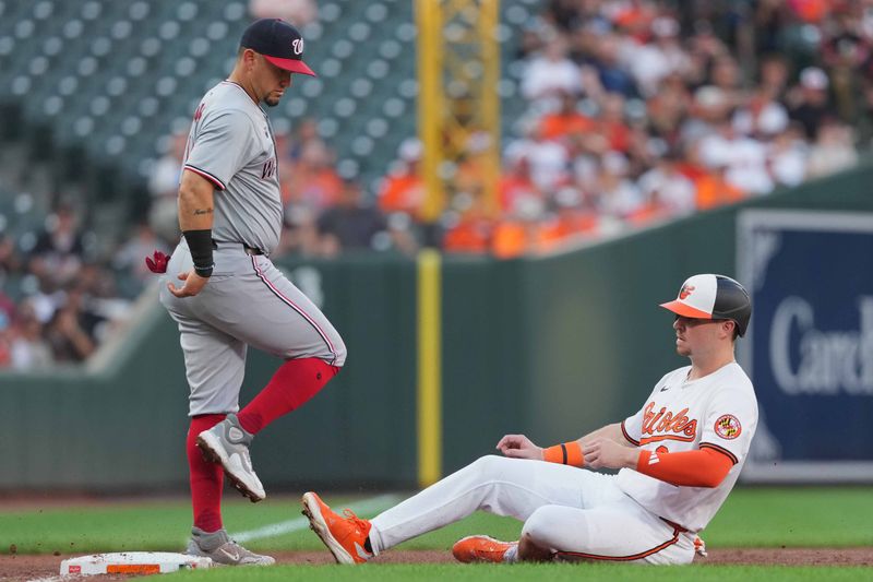 Aug 13, 2024; Baltimore, Maryland, USA; Baltimore Orioles designated hitter Ryan O’Hearn (32) slides into third base on a hit by catcher Adley Rutschman (not shown) during the second inning against the Washington Nationals at Oriole Park at Camden Yards. Mandatory Credit: Mitch Stringer-USA TODAY Sports