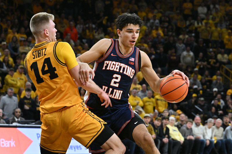 Jan 11, 2026; Iowa City, Iowa, USA; Illinois Fighting Illini guard Andrej Stojakovic (2) goes to the basket as Iowa Hawkeyes guard Bennett Stirtz (14) defends during the first half at Carver-Hawkeye Arena. Mandatory Credit: Jeffrey Becker-Imagn Images
