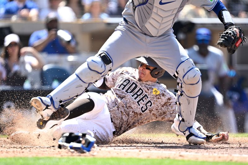 Apr 21, 2024; San Diego, California, USA; San Diego Padres designated hitter Manny Machado (13) is forced out at home by Toronto Blue Jays catcher Danny Jansen (9) during the sixth inning at Petco Park. Mandatory Credit: Orlando Ramirez-USA TODAY Sports