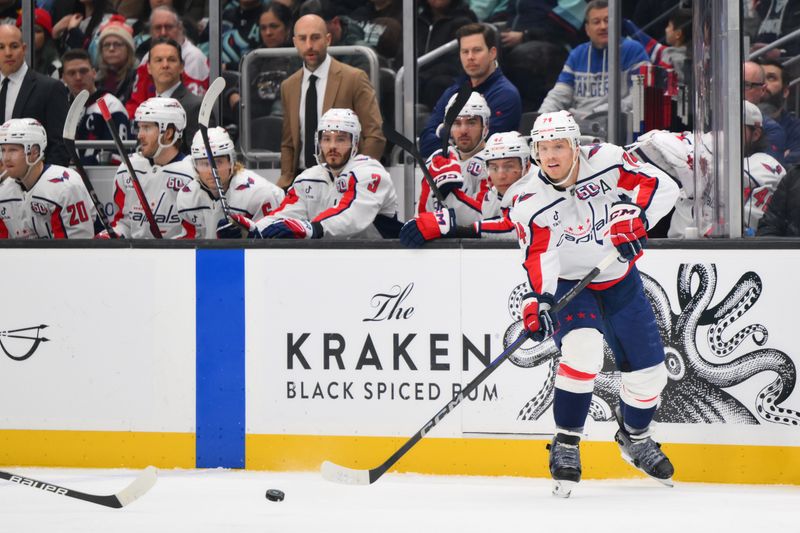 Jan 23, 2025; Seattle, Washington, USA; Washington Capitals defenseman John Carlson (74) passes the puck during the first period against the Seattle Kraken at Climate Pledge Arena. Mandatory Credit: Steven Bisig-Imagn Images