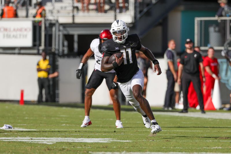 Oct 12, 2024; Orlando, Florida, USA; UCF Knights quarterback Jacurri Brown (11) runs the ball during the second quarter against the Cincinnati Bearcats at FBC Mortgage Stadium. Mandatory Credit: Mike Watters-Imagn Images