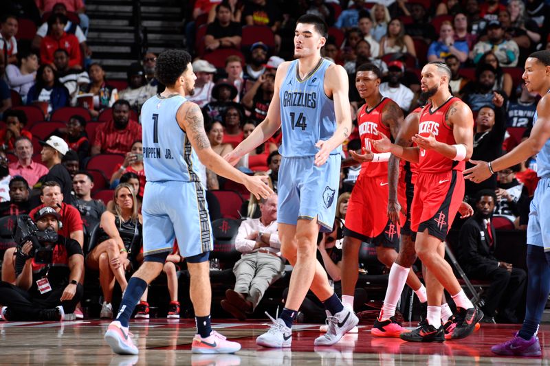 HOUSTON, TX - OCTOBER 25: Zach Edey #14 of the Memphis Grizzlies celebrates during the game against the Houston Rockets on October 25, 2024 at the Toyota Center in Houston, Texas. NOTE TO USER: User expressly acknowledges and agrees that, by downloading and or using this photograph, User is consenting to the terms and conditions of the Getty Images License Agreement. Mandatory Copyright Notice: Copyright 2024 NBAE (Photo by Logan Riely/NBAE via Getty Images)