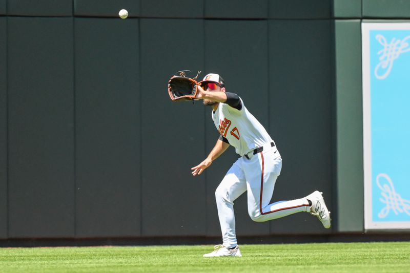 May 2, 2024; Baltimore, Maryland, USA;  Baltimore Orioles left fielder Colton Cowser makes a catch during the second inning against the New York Yankees at Oriole Park at Camden Yards. Mandatory Credit: James A. Pittman-USA TODAY Sports