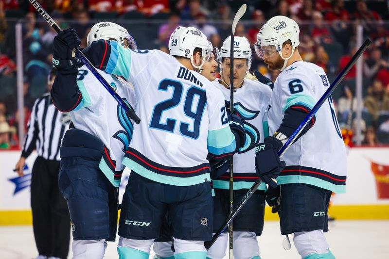 Mar 4, 2024; Calgary, Alberta, CAN; Seattle Kraken center Yanni Gourde (37) celebrates his goal with teammates against the Calgary Flames during the first period at Scotiabank Saddledome. Mandatory Credit: Sergei Belski-USA TODAY Sports