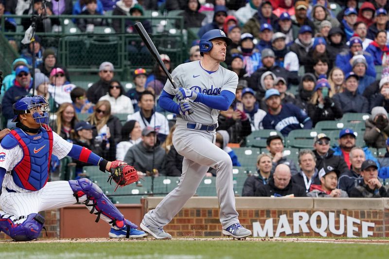 Apr 7, 2024; Chicago, Illinois, USA; Los Angeles Dodgers first baseman Freddie Freeman (5) hits a single against the Chicago Cubs during the first inning at Wrigley Field. Mandatory Credit: David Banks-USA TODAY Sports