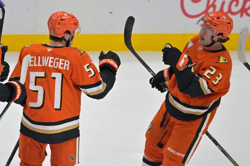 Nov 5, 2024; Anaheim, California, USA; Anaheim Ducks defenseman Olen Zellweger (51) is congratulated by center Mason McTavish (23) after scoring a goal in the first period against the Vancouver Canucks at Honda Center. Mandatory Credit: Jayne Kamin-Oncea-Imagn Images