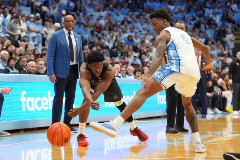 Feb 28, 2026; Chapel Hill, North Carolina, USA; Virginia Tech Hokies guard Tyler Johnson (10) passes the ball as North Carolina Tar Heels guard Jaydon Young (4) defends in the first half at Dean E. Smith Center. Mandatory Credit: Bob Donnan-Imagn Images