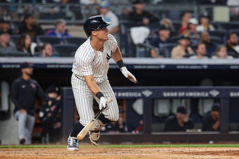 Aug 20, 2024; Bronx, New York, USA; New York Yankees shortstop Anthony Volpe (11) hits an RBI double during the fourth inning against the Cleveland Guardians at Yankee Stadium. Mandatory Credit: Vincent Carchietta-USA TODAY Sports