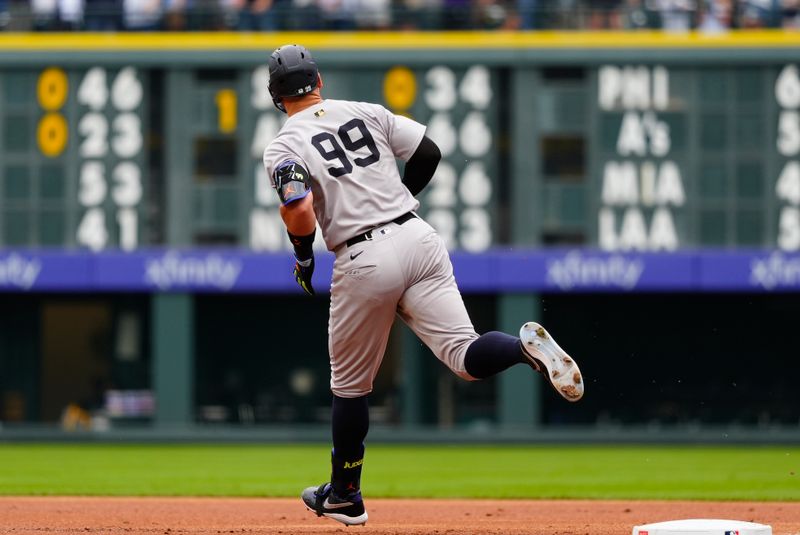 May 24, 2025; Denver, Colorado, USA; New York Yankees right fielder Aaron Judge (99) runs off solo home run in the first inning against the Colorado Rockies at Coors Field. Mandatory Credit: Ron Chenoy-Imagn Images