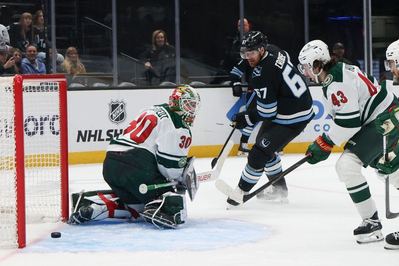Feb 27, 2026; Salt Lake City, Utah, USA; Utah Mammoth left wing Lawson Crouse (67) scores a goal against Minnesota Wild goaltender Jesper Wallstedt (30) and defenseman Quinn Hughes (43) during the second period at Delta Center. Mandatory Credit: Rob Gray-Imagn Images