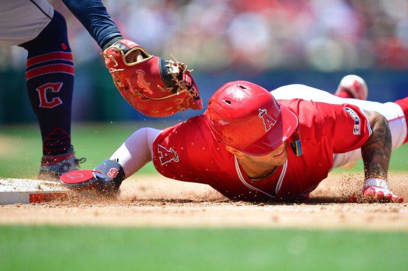 May 26, 2024; Anaheim, California, USA; Los Angeles Angels shortstop Zach Neto (9) slides back to first against Cleveland Guardians first base Josh Naylor (22) during the fifth inning at Angel Stadium. Mandatory Credit: Gary A. Vasquez-USA TODAY Sports