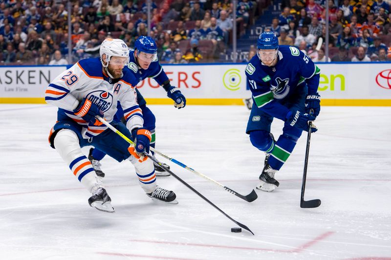 May 20, 2024; Vancouver, British Columbia, CAN; Vancouver Canucks defenseman Nikita Zadorov (91) and defenseman Tyler Myers (57) defend against Edmonton Oilers forward Leon Draisaitl (29) during the second period in game seven of the second round of the 2024 Stanley Cup Playoffs at Rogers Arena. Mandatory Credit: Bob Frid-USA TODAY Sports