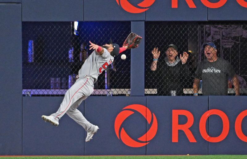 May 1, 2025; Toronto, Ontario, CAN; Boston Red Sox right fielder Wilyer Abreu (52) fails to catch a ball hit for a double by Toronto Blue Jay shortstop Bo Bichette (not shown) in the eighth inning at Rogers Centre. Mandatory Credit: Dan Hamilton-Imagn Images