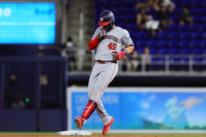 Apr 29, 2024; Miami, Florida, USA; Washington Nationals first baseman Joey Meneses (45) reaches second base after hitting a double against the Miami Marlins during the seventh inning at loanDepot Park. Mandatory Credit: Sam Navarro-USA TODAY Sports