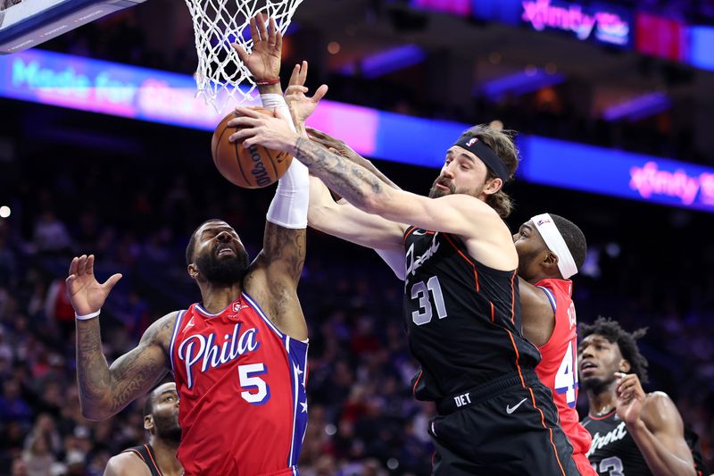 PHILADELPHIA, PENNSYLVANIA - DECEMBER 15: Marcus Morris Sr. #5 of the Philadelphia 76ers and Joe Harris #31 of the Detroit Pistons challenge for the ball during the fourth quarter at the Wells Fargo Center on December 15, 2023 in Philadelphia, Pennsylvania. NOTE TO USER: User expressly acknowledges and agrees that, by downloading and or using this photograph, User is consenting to the terms and conditions of the Getty Images License Agreement. (Photo by Tim Nwachukwu/Getty Images)