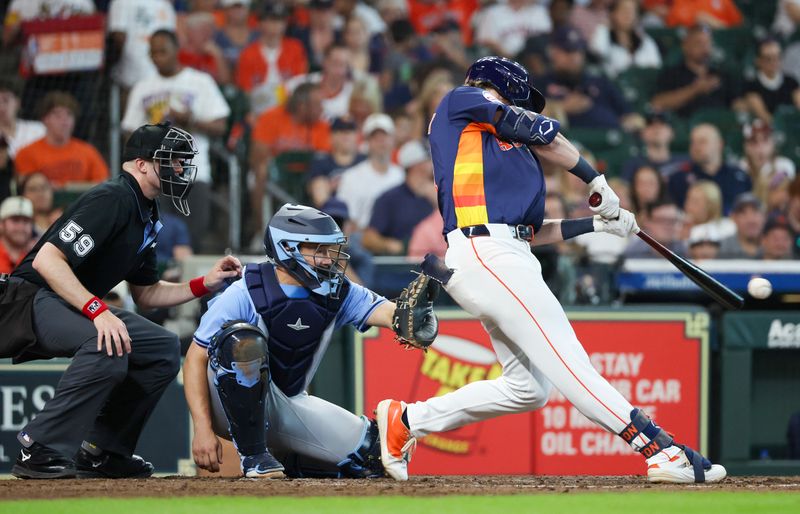 Jun 1, 2025; Houston, Texas, USA; Houston Astros center fielder Jacob Melton (31) hits a single against the Tampa Bay Rays  in the fifth inning at Daikin Park. Mandatory Credit: Thomas Shea-Imagn Images